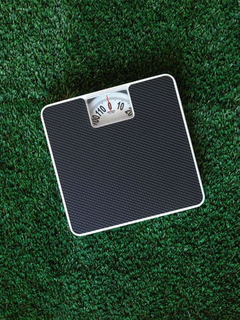 Bathroom scales isolated against green grassの写真素材