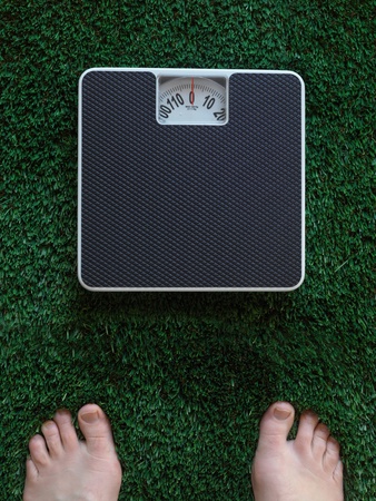Bathroom scales isolated against green grassの写真素材