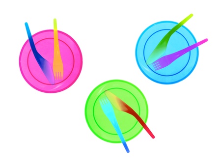 Plastic plates and cutlery over a white backgroundの写真素材