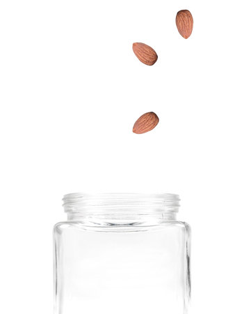 Almond nuts isolated against a white backgroundの写真素材