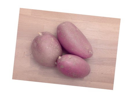 A close up shot of potatoes on a chopping boardの写真素材
