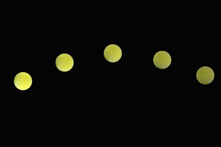 An abstract image of a tennis ball on blackの写真素材