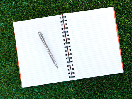 A close up shot of a note book on artificial grass