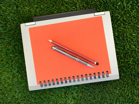 A laptop computer on artificial grassの写真素材