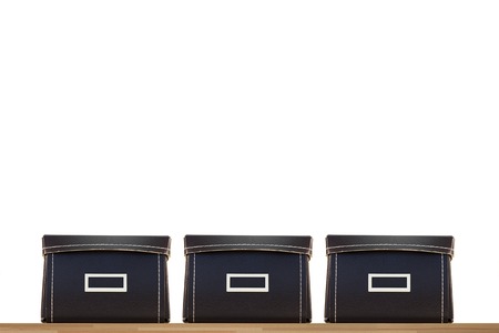 Storage boxes isolated on a wooden shelfの写真素材