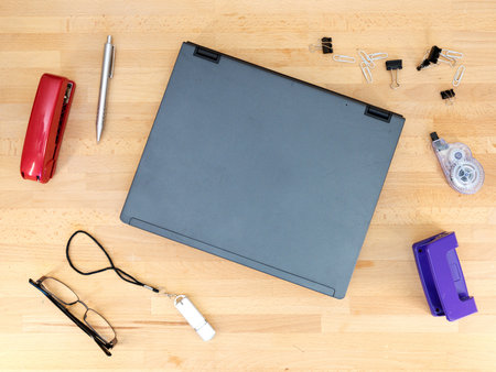 Stationery and work objects on a wooden  office deskの写真素材