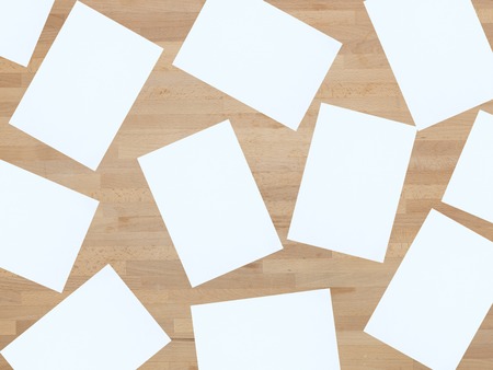 Blank A4 office paper on a wooden floorの写真素材