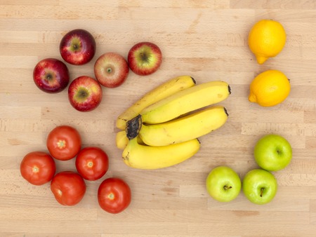 Assorted fruit placed on a wooden surfaceの写真素材