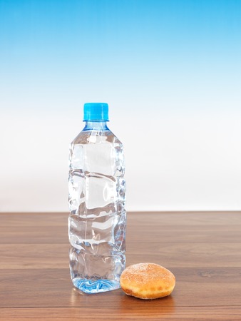 A conceptual image of a bottle of water and a donutの写真素材