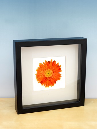 A photo frame on a wooden shelfの写真素材