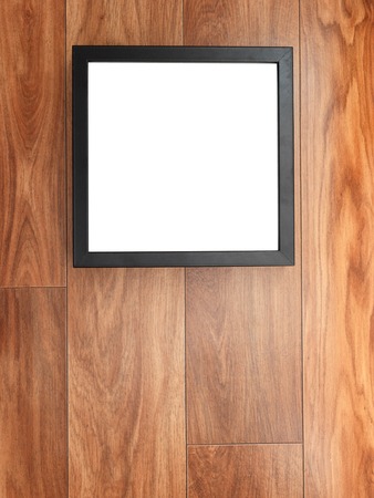 A photo frame on a wooden shelfの写真素材