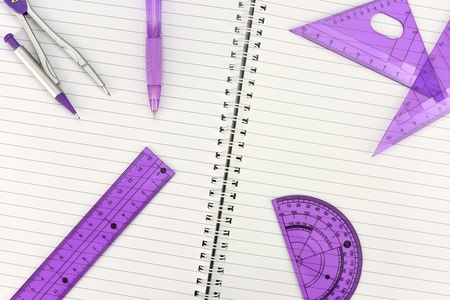 A close up photo of a geometry set on note bookの写真素材