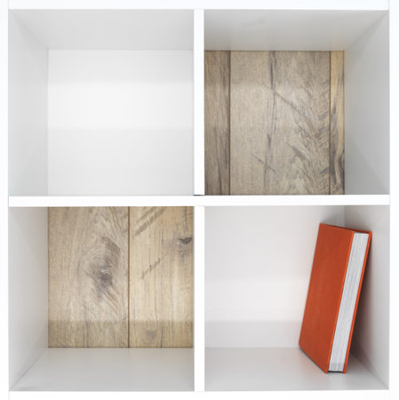 A studio photo of a simple white bookcase