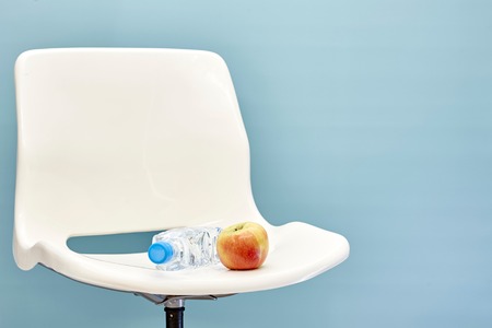 A studio photo of a white swivel chairの写真素材