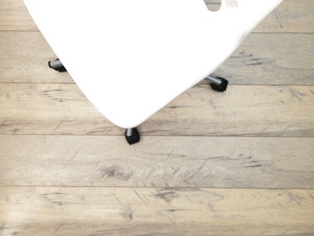 A studio photo of a white swivel chairの写真素材
