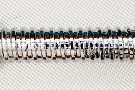 A close up studio photo of a metal thread