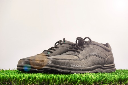 A studio photo of black walking shoesの写真素材