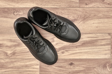 A studio photo of black walking shoesの写真素材