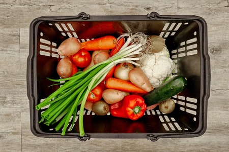 A studio photo of a fruit and vegetable basketの写真素材