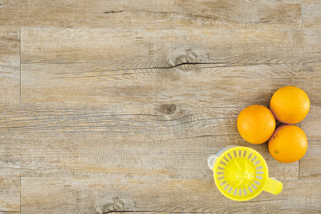 A studio photo of a hand juicer with fruit