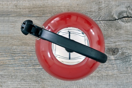 A studio photo of a red stove kettleの写真素材