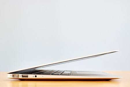 A laptop computer on a wooden deskの写真素材