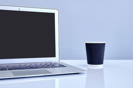 A laptop computer on a wooden deskの写真素材