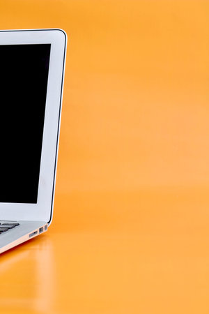 A laptop computer on a wooden desk