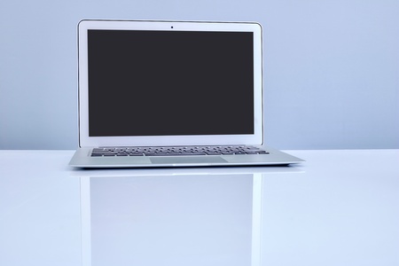 A laptop computer on a wooden deskの写真素材