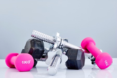 A studio photo of a silver gym dumbbellの写真素材