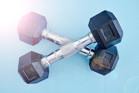 A studio photo of a black gym dumbbellの写真素材