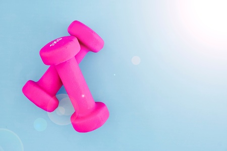 A studio photo of a pink gym dumbbellの写真素材