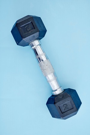 A studio photo of a black gym dumbbellの写真素材
