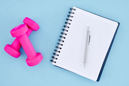 A studio photo of a pink gym dumbbellの写真素材