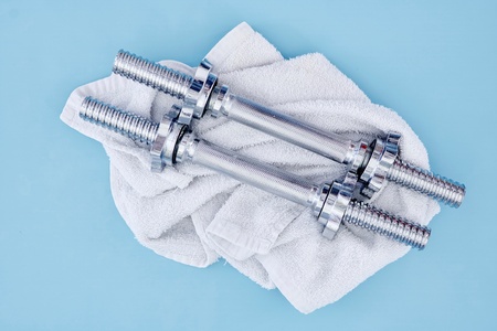 A studio photo of a silver gym dumbbellの写真素材