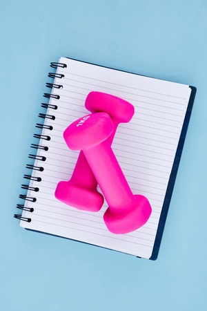 A studio photo of a pink gym dumbbellの写真素材