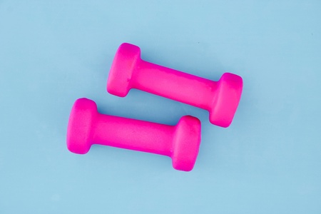 A studio photo of a pink gym dumbbellの写真素材