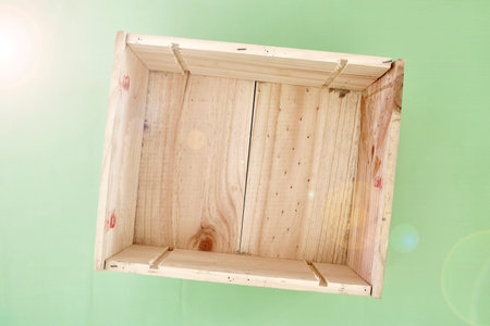 A studio photo of an empty pine box