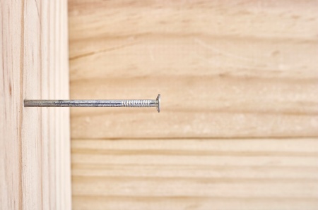 A studio photo of nailing into woodの写真素材