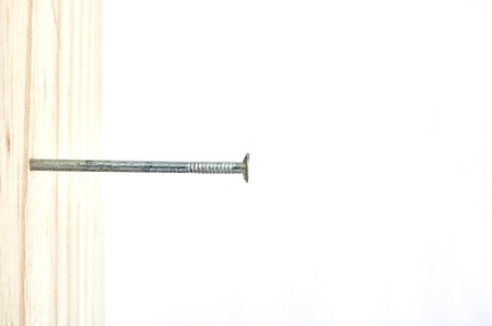 A studio photo of nailing into woodの写真素材