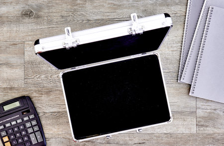 A studio photo of an old leather briefcase