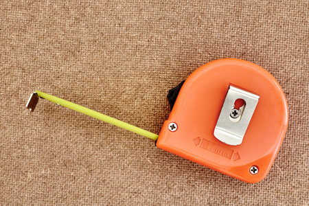 A studio photo of a measuring tape
