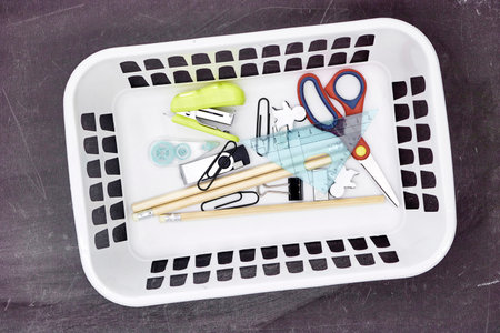 A studio photo of a white plastic storage basket
