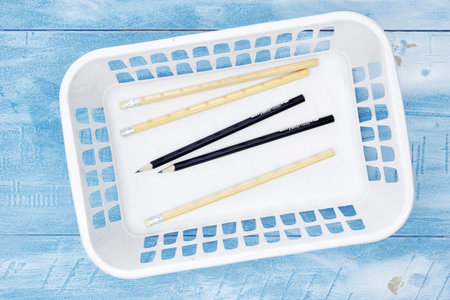 A studio photo of a white plastic storage basket