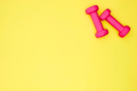 A studio photo of pink dumbellsの写真素材