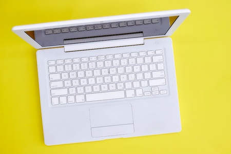 A laptop computer on a wooden deskの写真素材