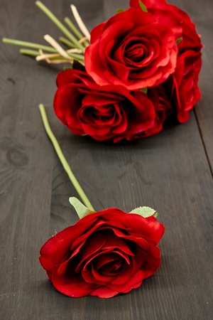 A studio photo of an artificial red roseの写真素材