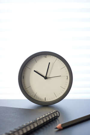 A studio photo of a desk clockの写真素材