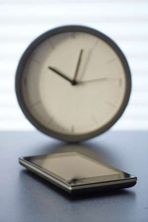 A studio photo of a mobile phone with headphonesの写真素材