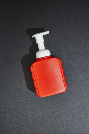 A studio photo of a mobile phone with headphonesの写真素材